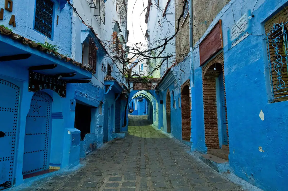 A blue-washed alley with arched doorways in Chefchaouen
